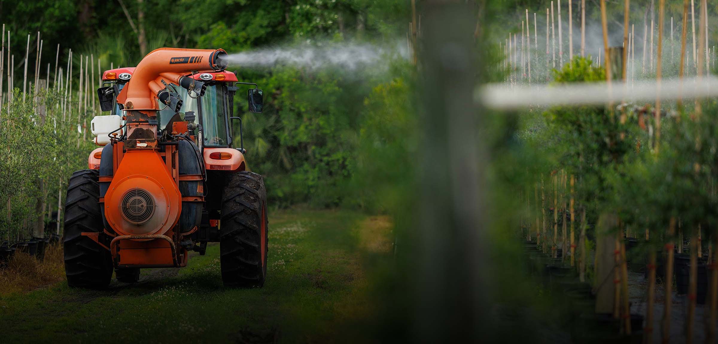 Tractor spraying crops with pest control treatment in a nursery — Pierson Supply pest and disease control solutions for growers