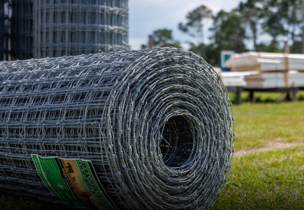 Roll of galvanized field fencing on grass