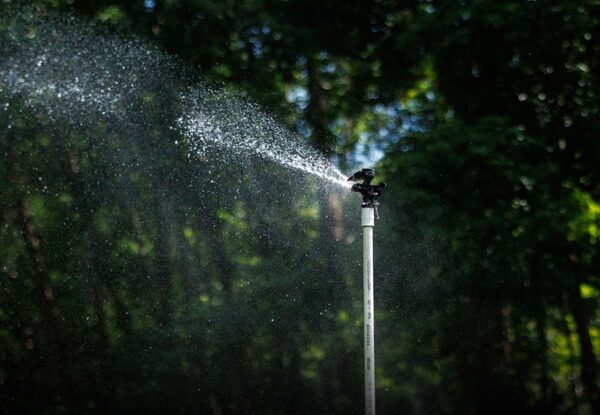 Overhead sprinkler spraying water across crops — Pierson Supply irrigation systems for farms and nurseries