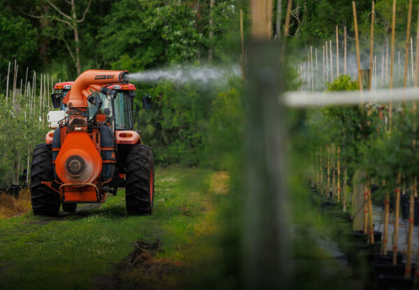 Tractor spraying crops with pest control treatment in a nursery — Pierson Supply pest and disease control solutions for growers